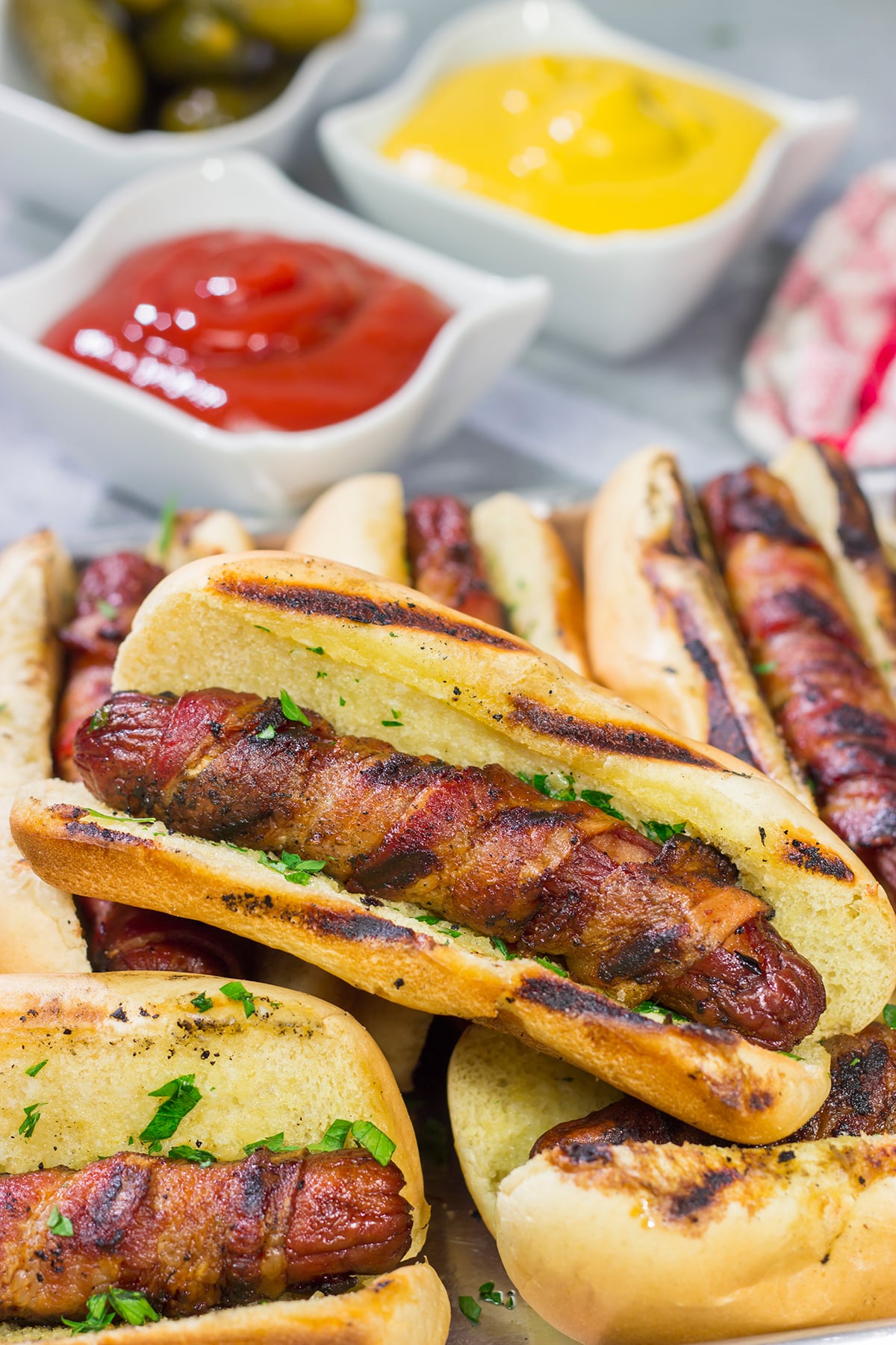 Holy hot dogs, Batman! No need for the oven here. These Grilled Bacon Wrapped Hot Dogs are cooked on the grill and served on a garlic bread buns. Yum!