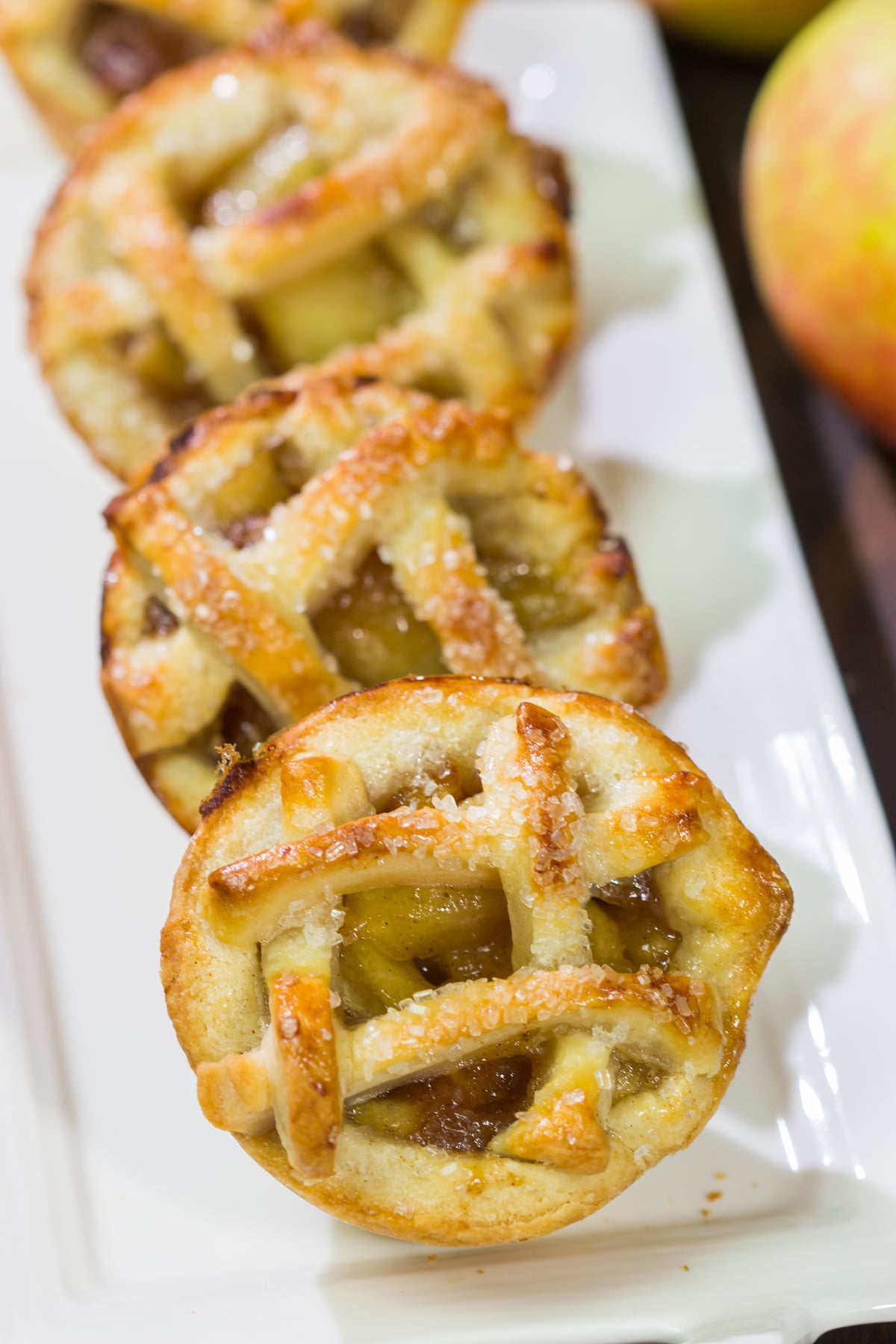 These Mini Apple Pies are baked in a muffin tin for an easy and fun twist on a classic apple pie. Grab some apples at a local orchard and whip up a batch of these pies for dessert!