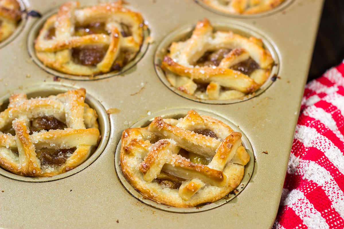 These Mini Apple Pies are baked in a muffin tin for an easy and fun twist on a classic apple pie. Grab some apples at a local orchard and whip up a batch of these pies for dessert!