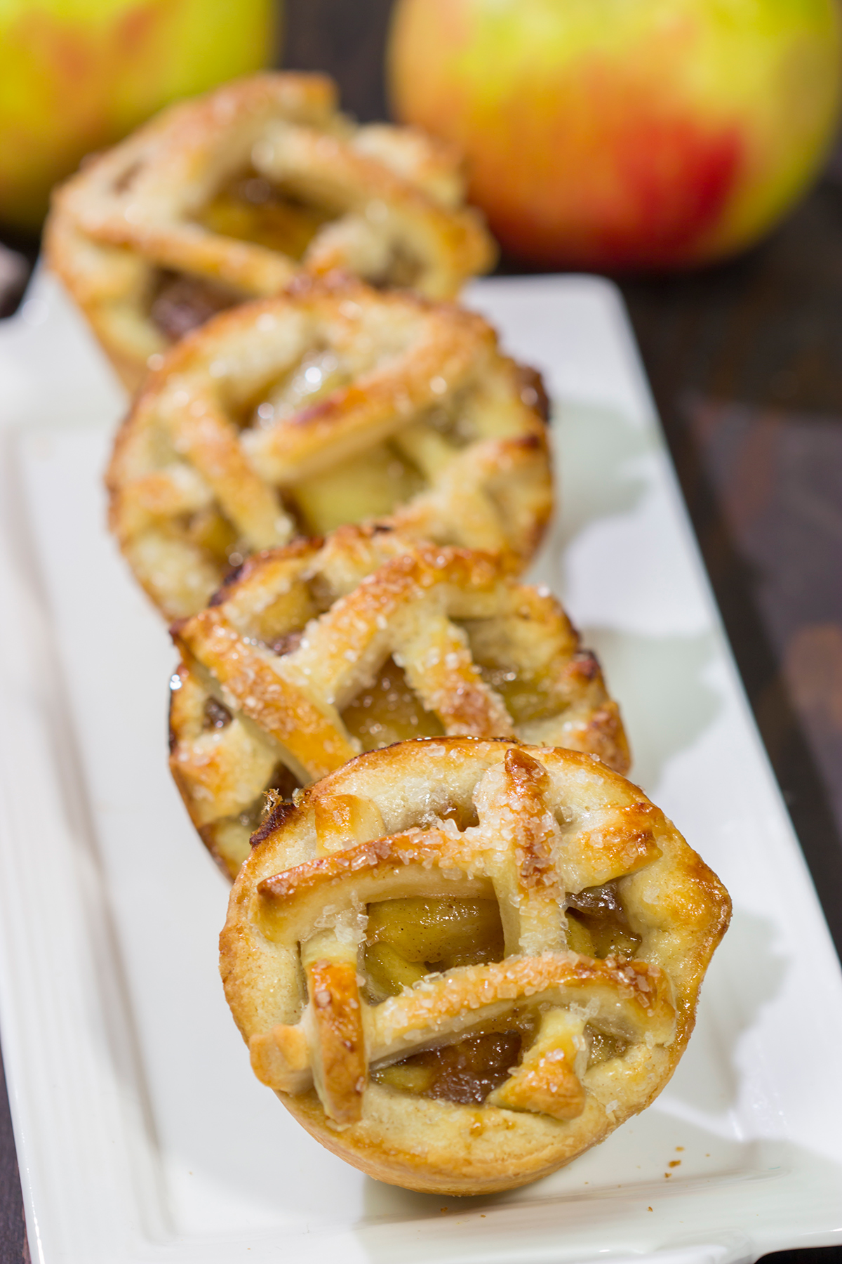 These Mini Apple Pies are baked in a muffin tin for an easy and fun twist on a classic apple pie. Grab some apples at a local orchard and whip up a batch of these pies for dessert!