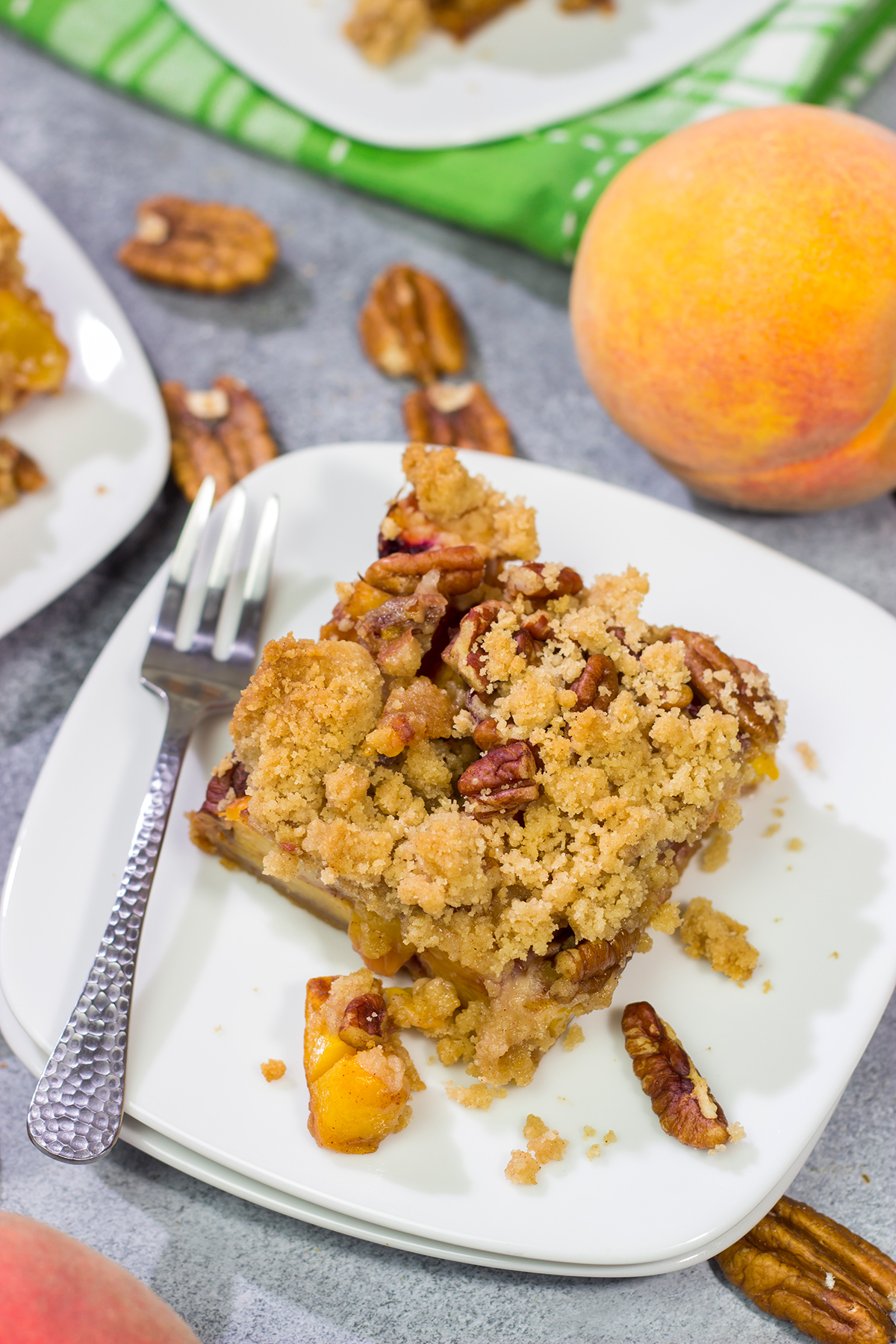 It's fresh peach season! These easy Peach Crumble Bars make for a fantastic summer dessert. Grab some peaches and get a batch of these bars in the oven today!