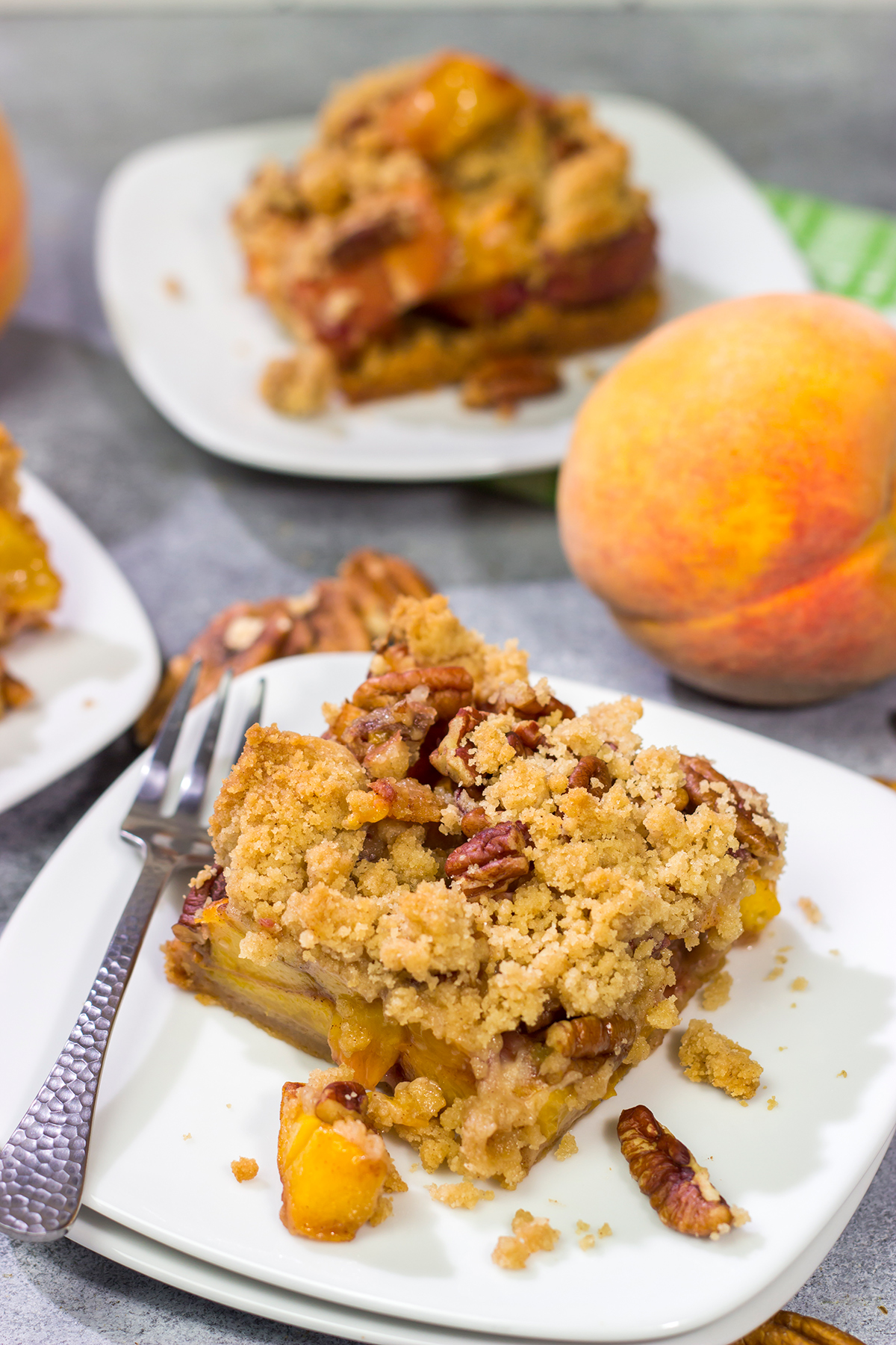 It's fresh peach season! These easy Peach Crumble Bars make for a fantastic summer dessert. Grab some peaches and get a batch of these bars in the oven today!