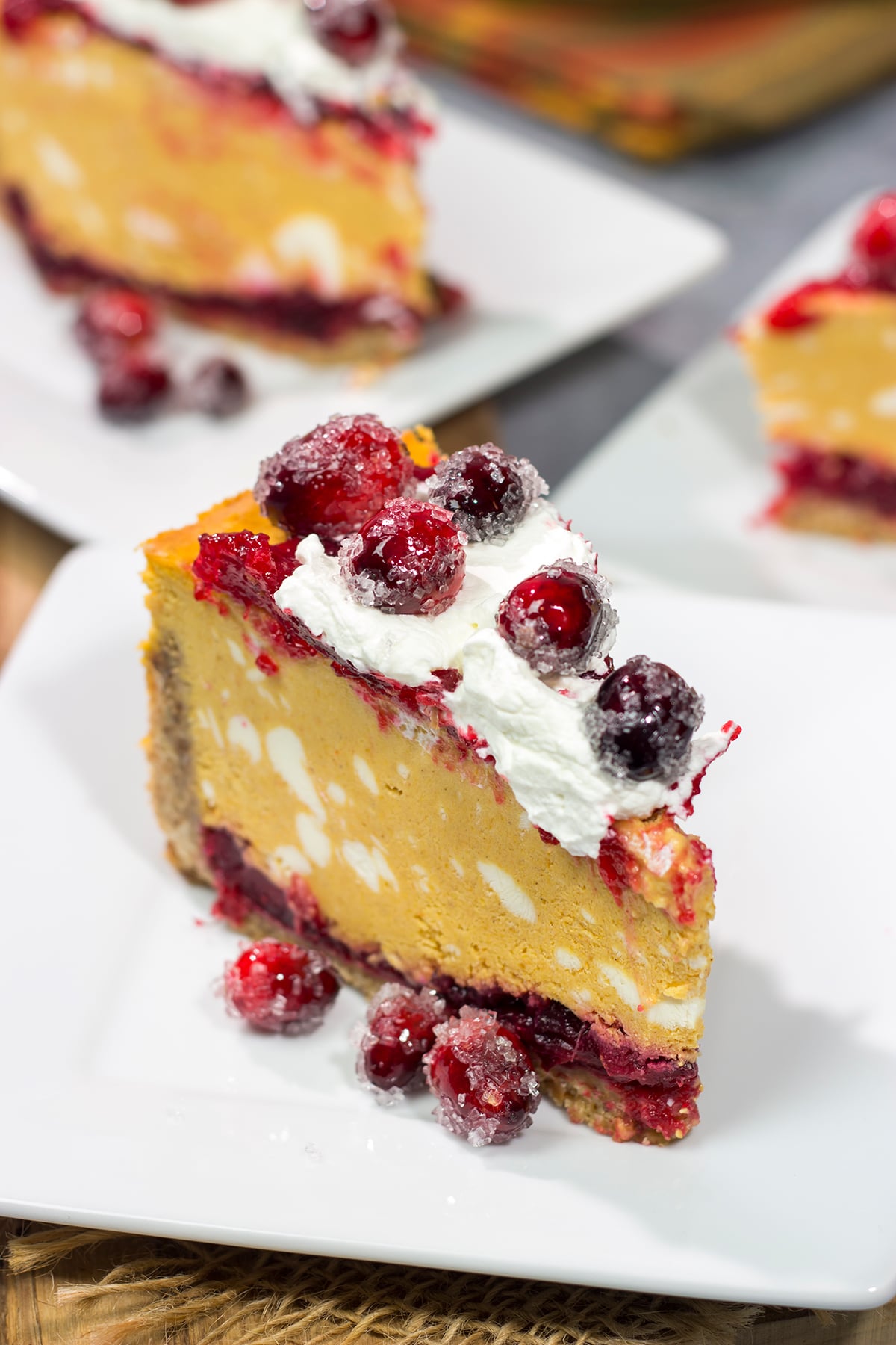 This Cranberry Pumpkin Cheesecake features a creamy pumpkin cheesecake over a layer of cranberry sauce. It's a delicious dessert that's perfect for fall!
