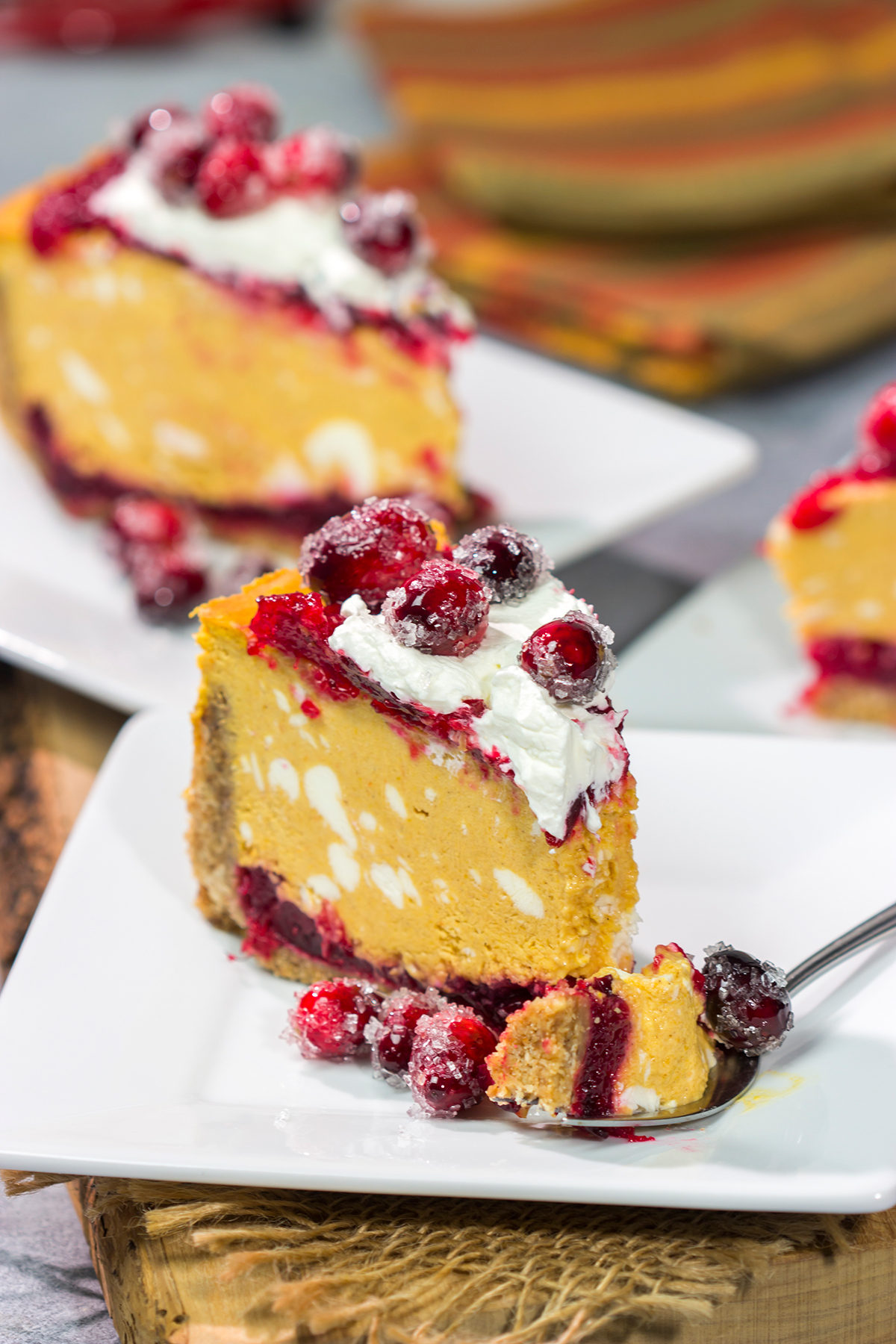 This Cranberry Pumpkin Cheesecake features a creamy pumpkin cheesecake over a layer of cranberry sauce. It's a delicious dessert that's perfect for fall!