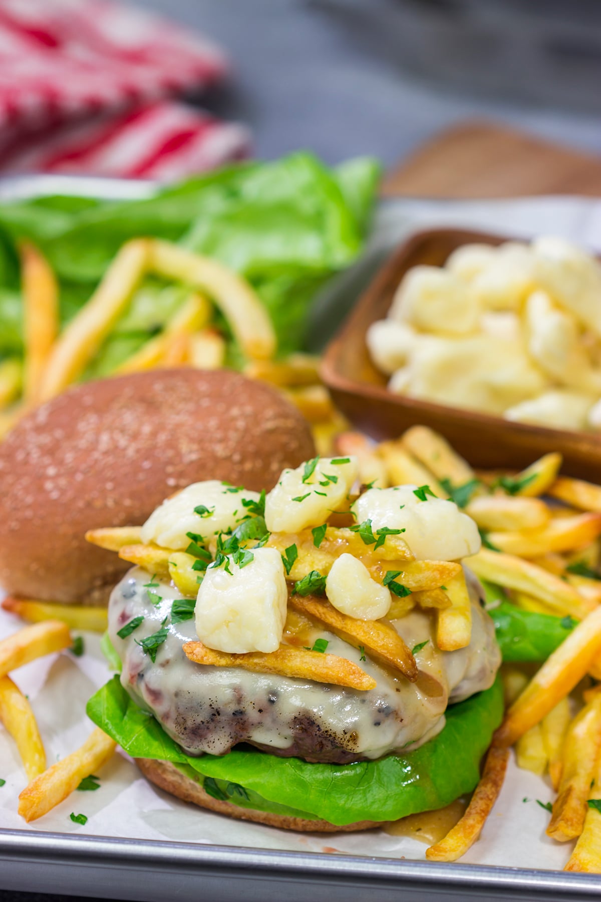 Topped with French fries, cheese curds and gravy, this Grilled Poutine Burger is a fun way to mix up summer grilling!