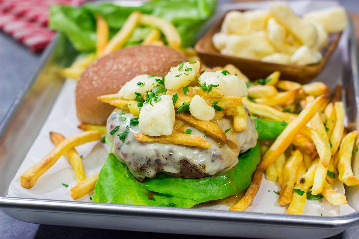 Topped with French fries, cheese curds and gravy, this Grilled Poutine Burger is a fun way to mix up summer grilling!