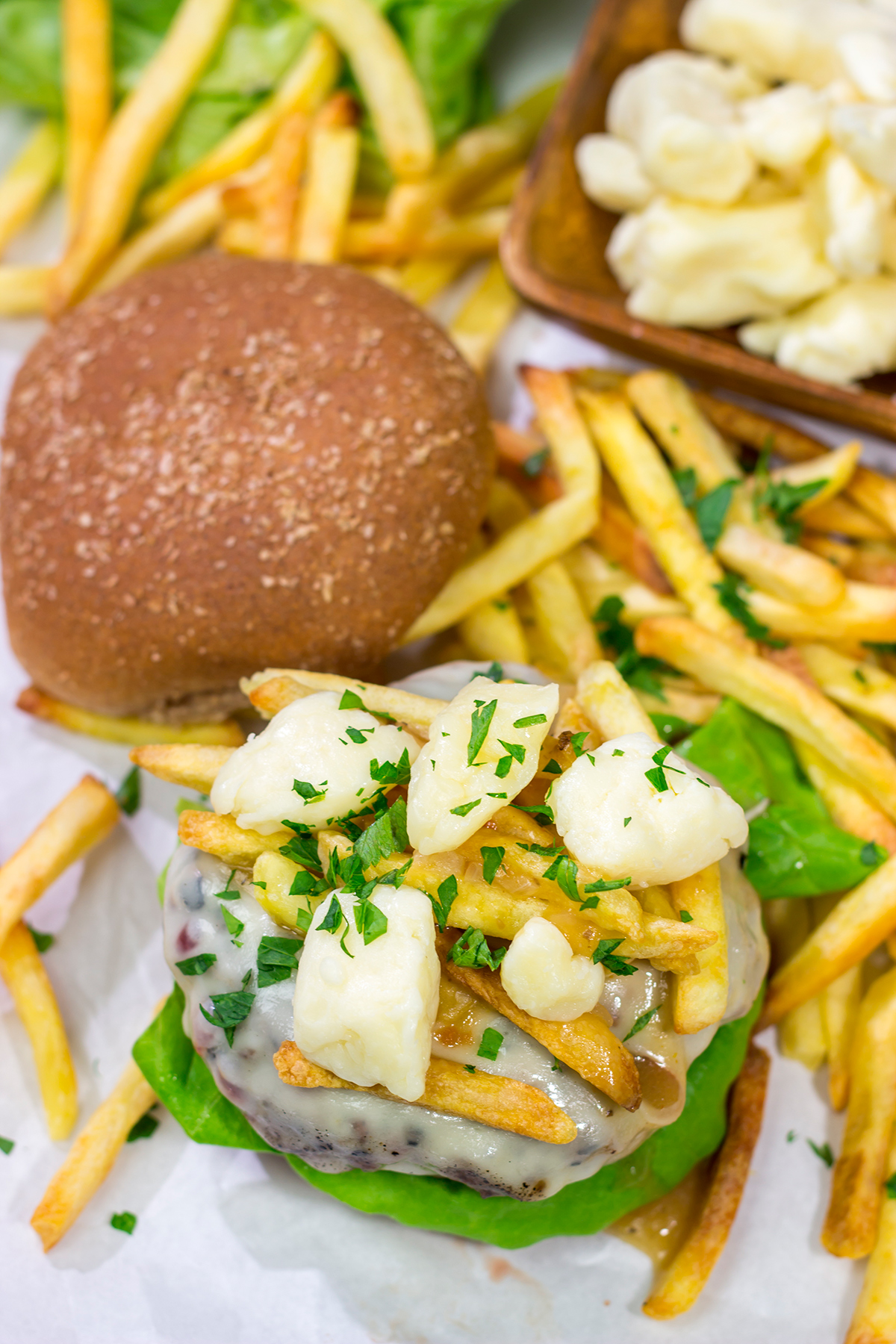 Topped with French fries, cheese curds and gravy, this Grilled Poutine Burger is a fun way to mix up summer grilling!