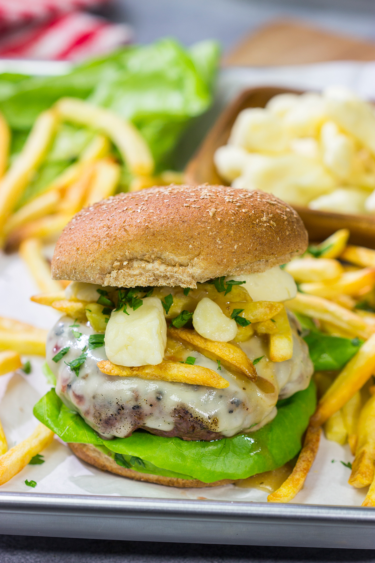Topped with French fries, cheese curds and gravy, this Grilled Poutine Burger is a fun way to mix up summer grilling!