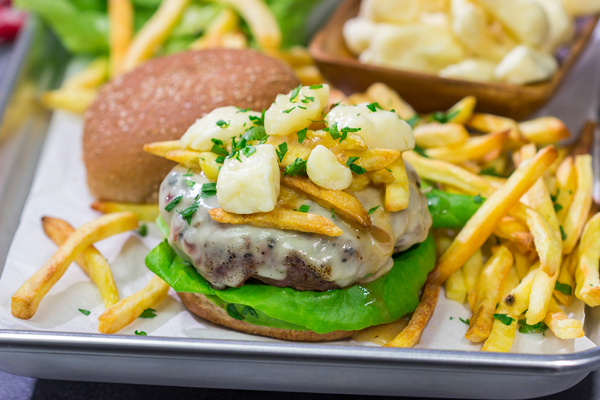 Topped with French fries, cheese curds and gravy, this Grilled Poutine Burger is a fun way to mix up summer grilling!