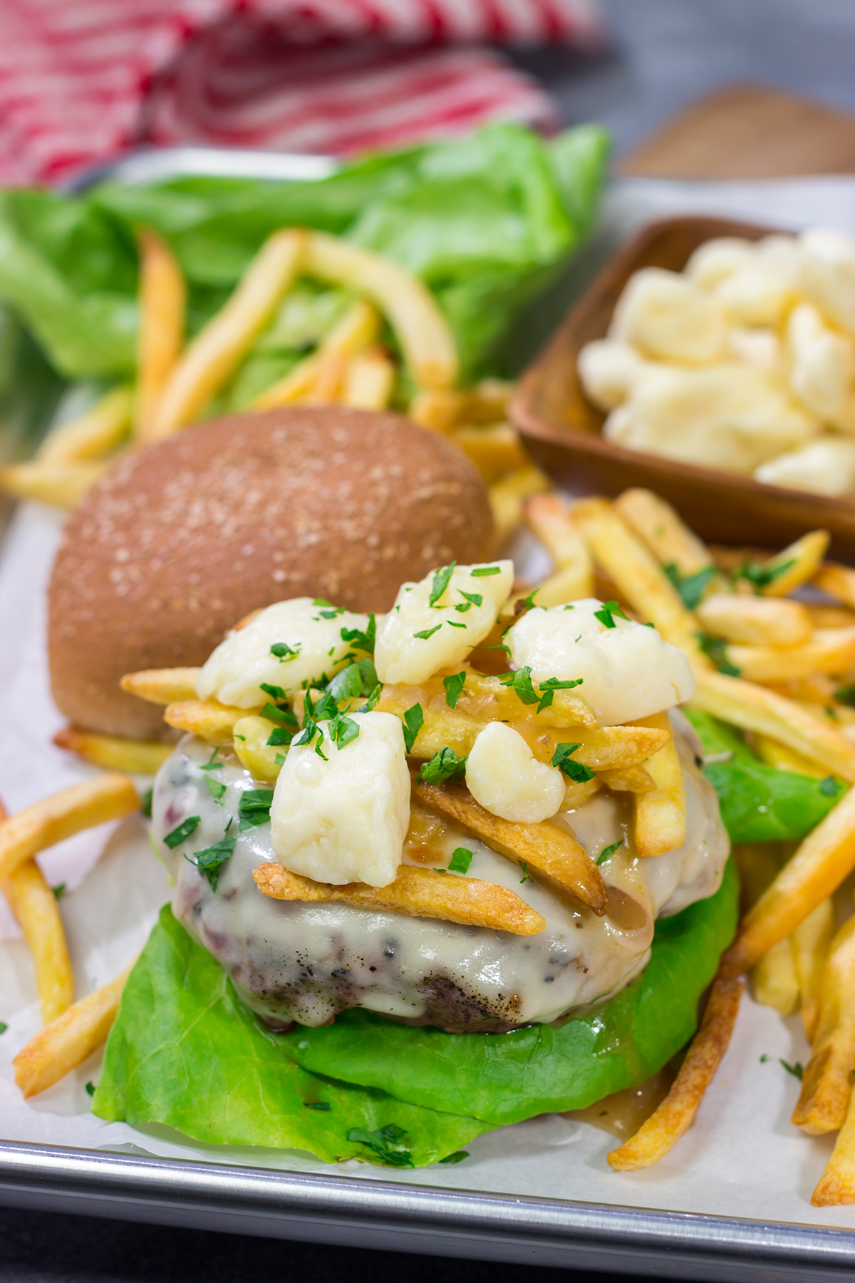 Topped with French fries, cheese curds and gravy, this Grilled Poutine Burger is a fun way to mix up summer grilling!