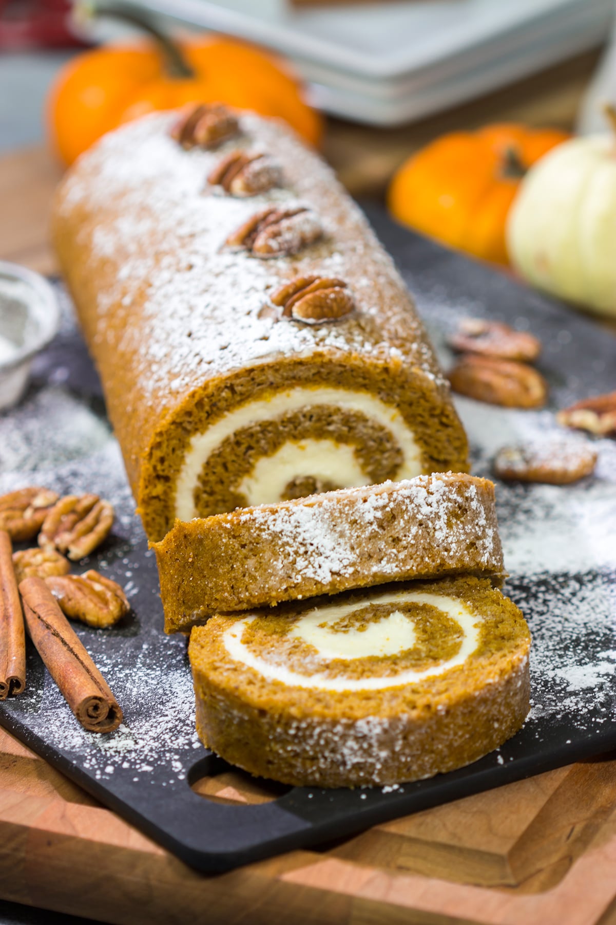 This Pumpkin Roll Cake features a spiced pumpkin bread filled with a delicious cream cheese frosting. It's a great dessert for celebrating chilly fall days!