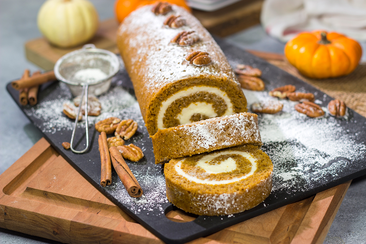 This Pumpkin Roll Cake features a spiced pumpkin bread filled with a delicious cream cheese frosting. It's a great dessert for celebrating chilly fall days!