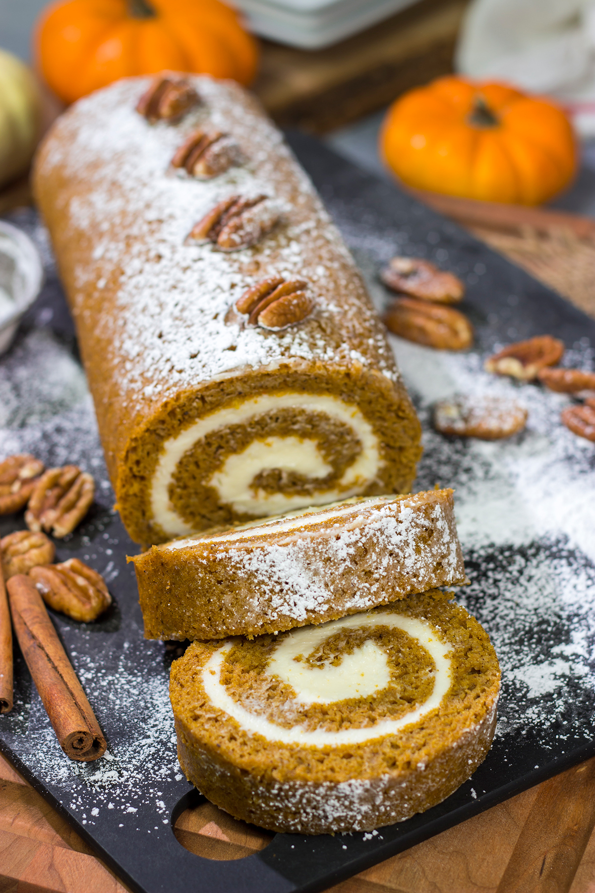 This Pumpkin Roll Cake features a spiced pumpkin bread filled with a delicious cream cheese frosting. It's a great dessert for celebrating chilly fall days!
