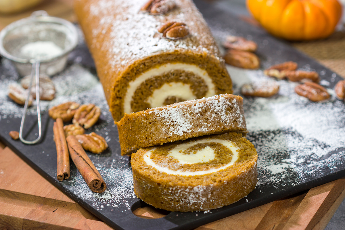This Pumpkin Roll Cake features a spiced pumpkin bread filled with a delicious cream cheese frosting. It's a great dessert for celebrating chilly fall days!
