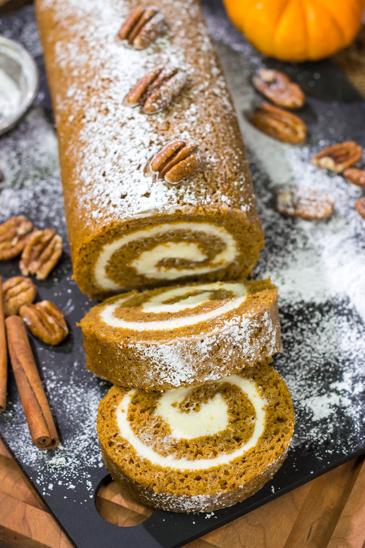 This Pumpkin Roll Cake features a spiced pumpkin bread filled with a delicious cream cheese frosting. It's a great dessert for celebrating chilly fall days!