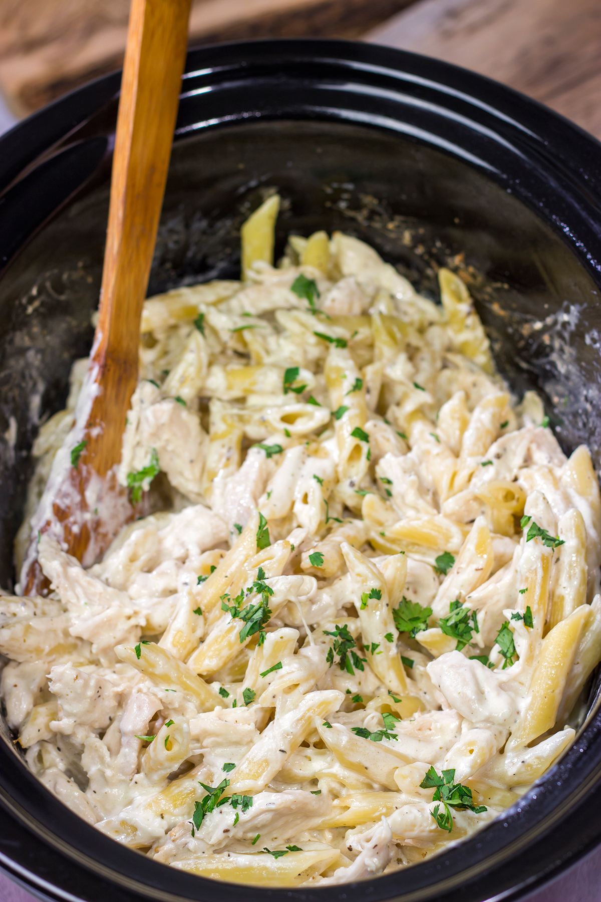 This Slow Cooker Chicken Alfredo recipe only requires about 10 minutes of prep time. It's the perfect comfort food to warm you up on a cold day!