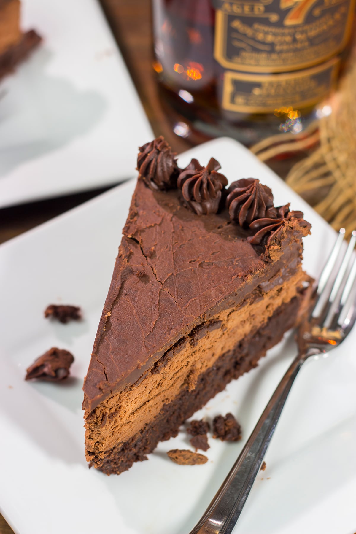 This 3-layer Bourbon Chocolate Mousse Cake is sure to satisfy any chocoholic in your life! Grab a slice for dessert tonight!