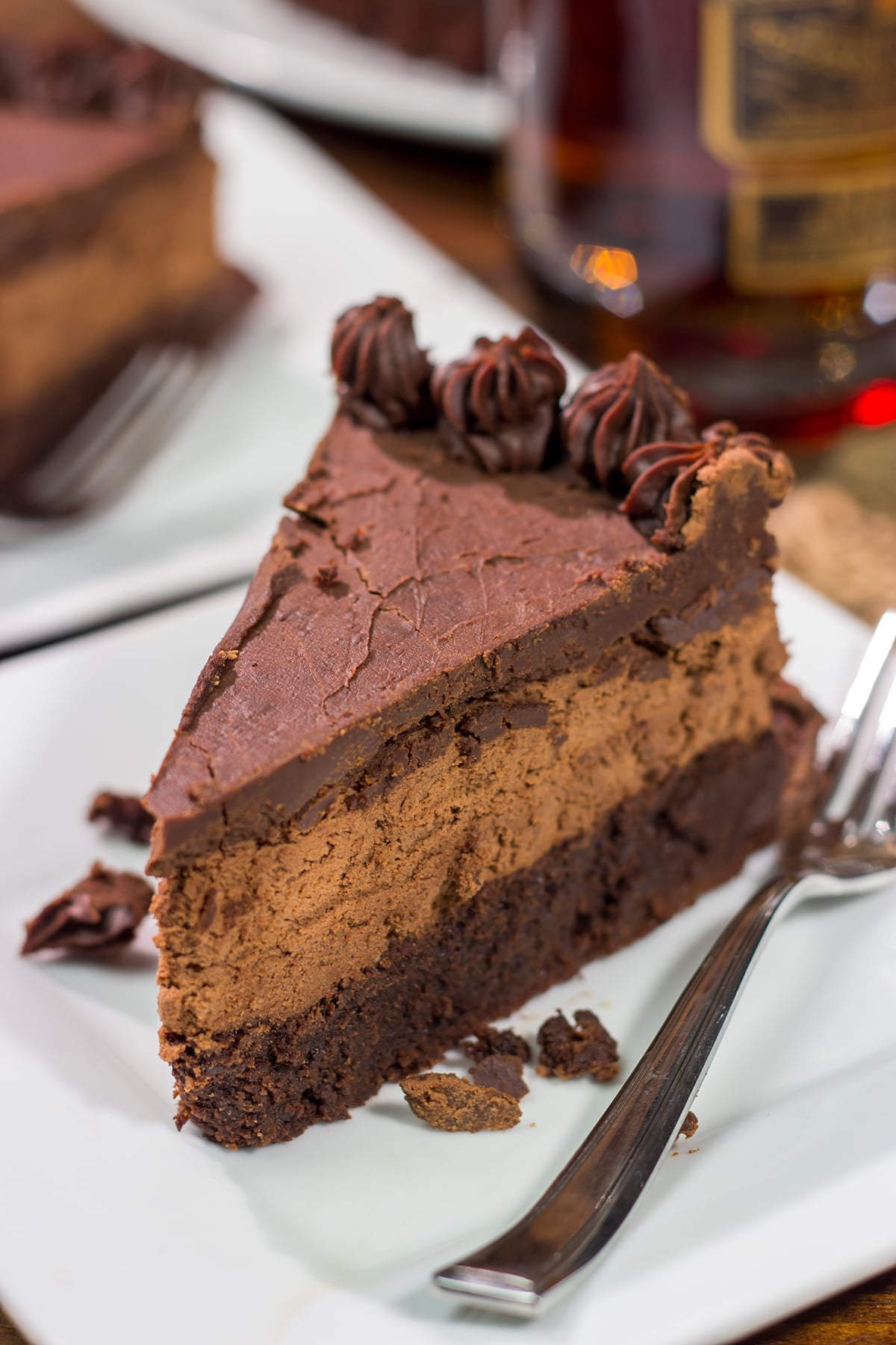 This 3-layer Bourbon Chocolate Mousse Cake is sure to satisfy any chocoholic in your life! Grab a slice for dessert tonight!