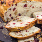 This no-knead Cranberry Walnut Bread is studded with dried cranberry and chopped walnuts. The result is a delicious loaf of rustic homemade bread!