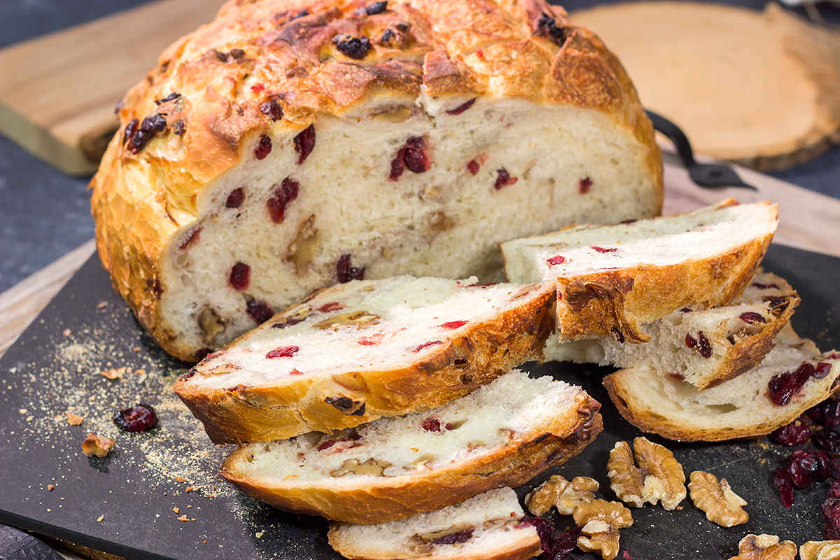 This no-knead Cranberry Walnut Bread is studded with dried cranberry and chopped walnuts. The result is a delicious loaf of rustic homemade bread!