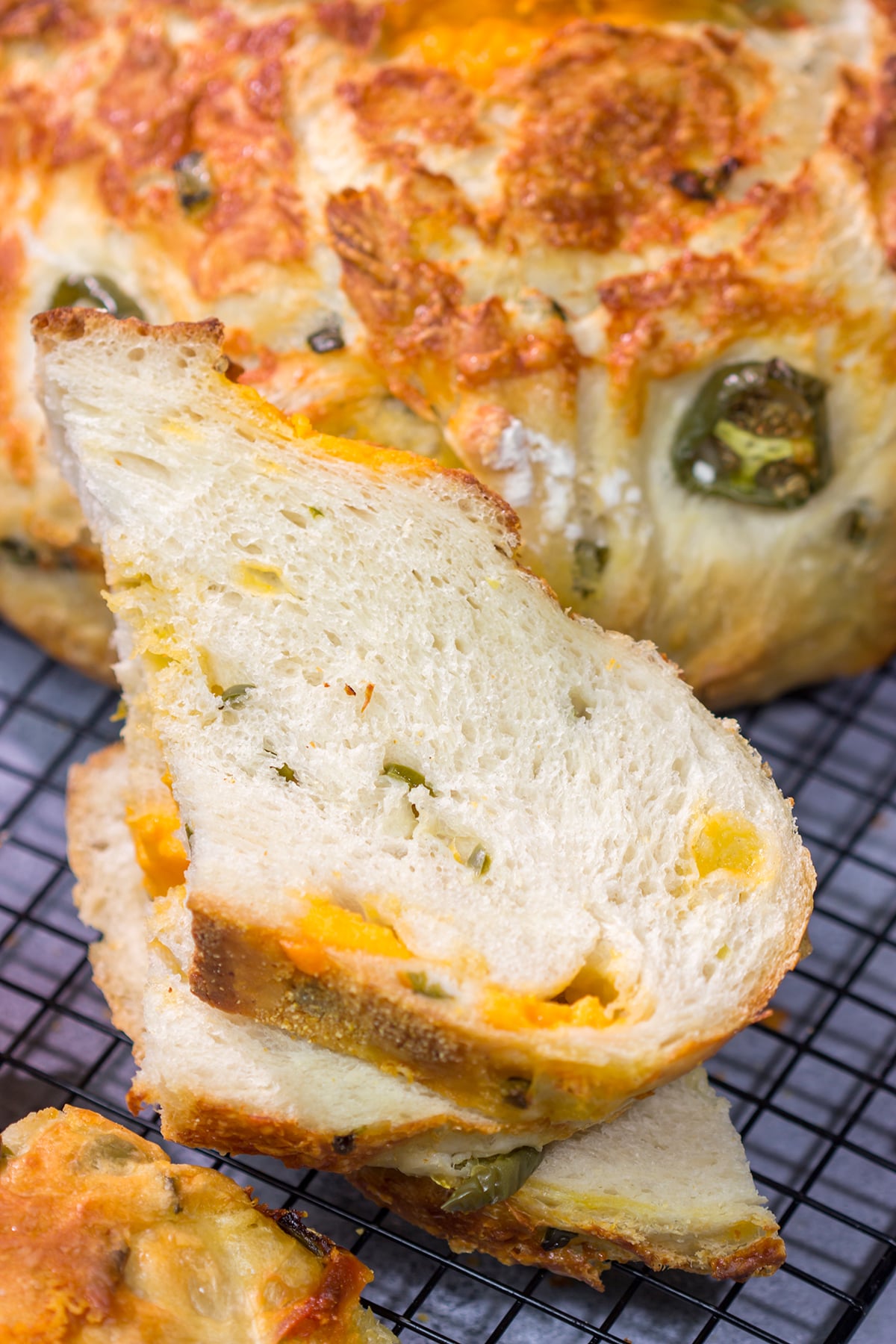 This Jalapeno Cheddar Bread features chunks of cheddar cheese and diced jalapenos mixed into a classic rustic bread. This bread makes fantastic grilled cheese sandwiches!!