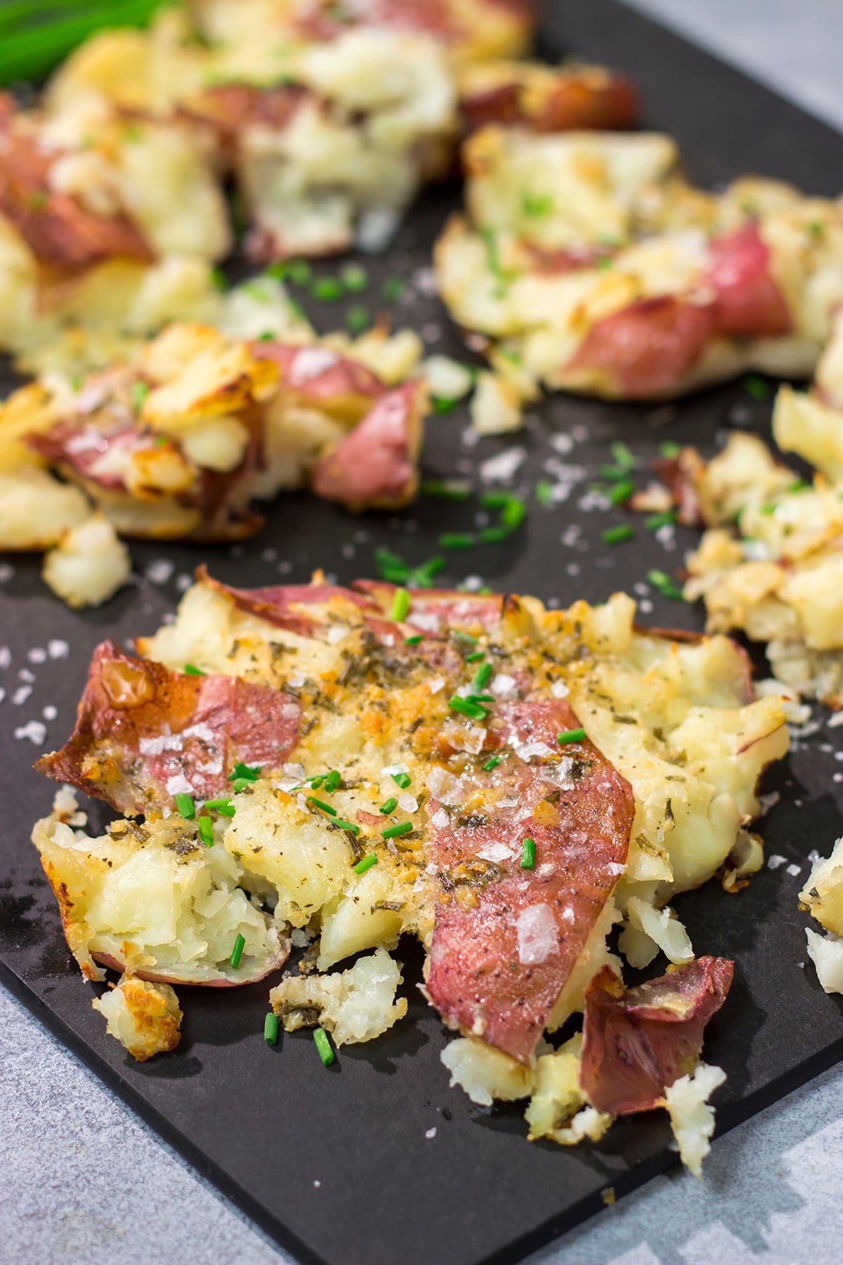 These Ranch Smashed Potatoes feature lots of crispy edges brushed with seasoned butter. These potatoes are perfect for when you need a new side dish recipe!