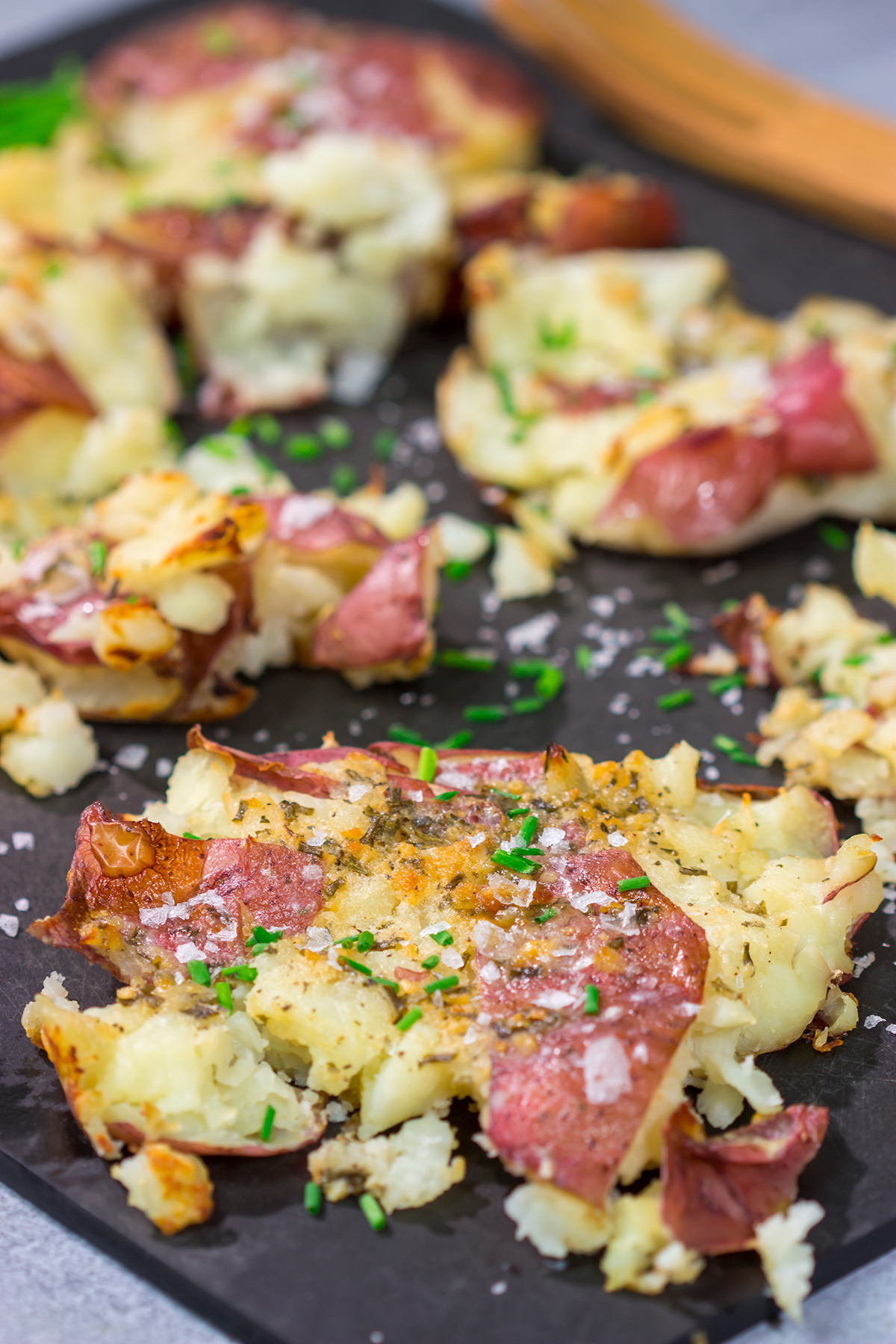 These Ranch Smashed Potatoes feature lots of crispy edges brushed with seasoned butter. These potatoes are perfect for when you need a new side dish recipe!
