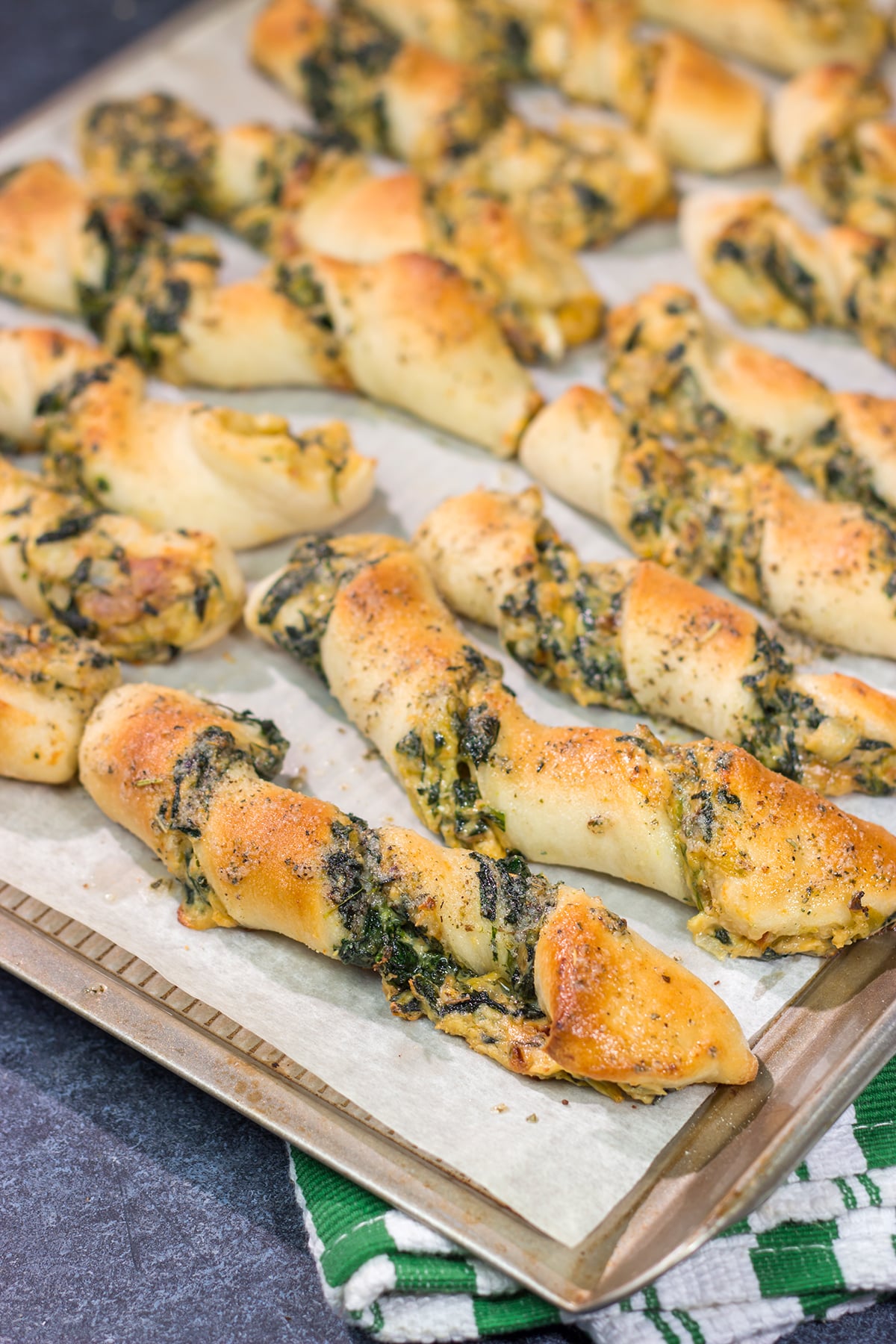 Looking for a tasty gameday appetizer? These Spinach Artichoke Breadsticks are a combination of garlic knots + spinach artichoke dip. They're delicious!