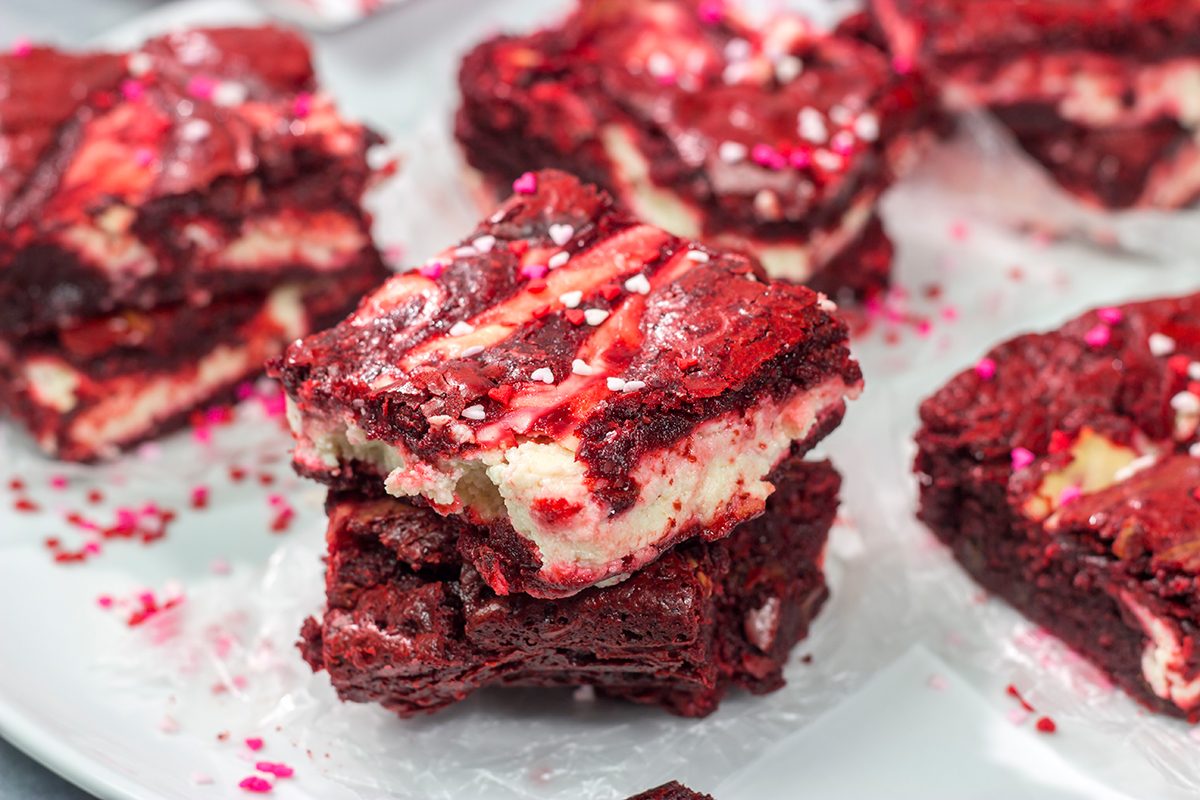 These Red Velvet Cheesecake Brownies feature tasty brownies swirled with a layer of cheesecake. They're a great dessert for Valentine's Day or Christmas!