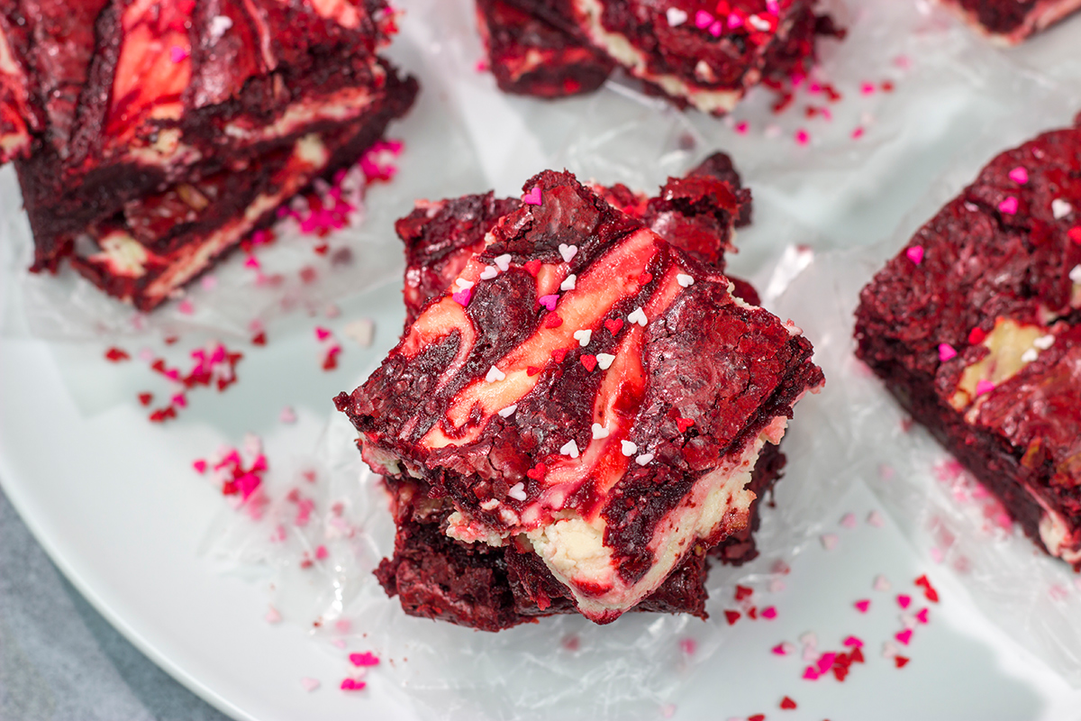 These Red Velvet Cheesecake Brownies feature tasty brownies swirled with a layer of cheesecake. They're a great dessert for Valentine's Day or Christmas!
