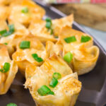 These Buffalo Chicken Wonton Cups feature creamy, mouthwatering buffalo chicken dip...in a bite-sized form!