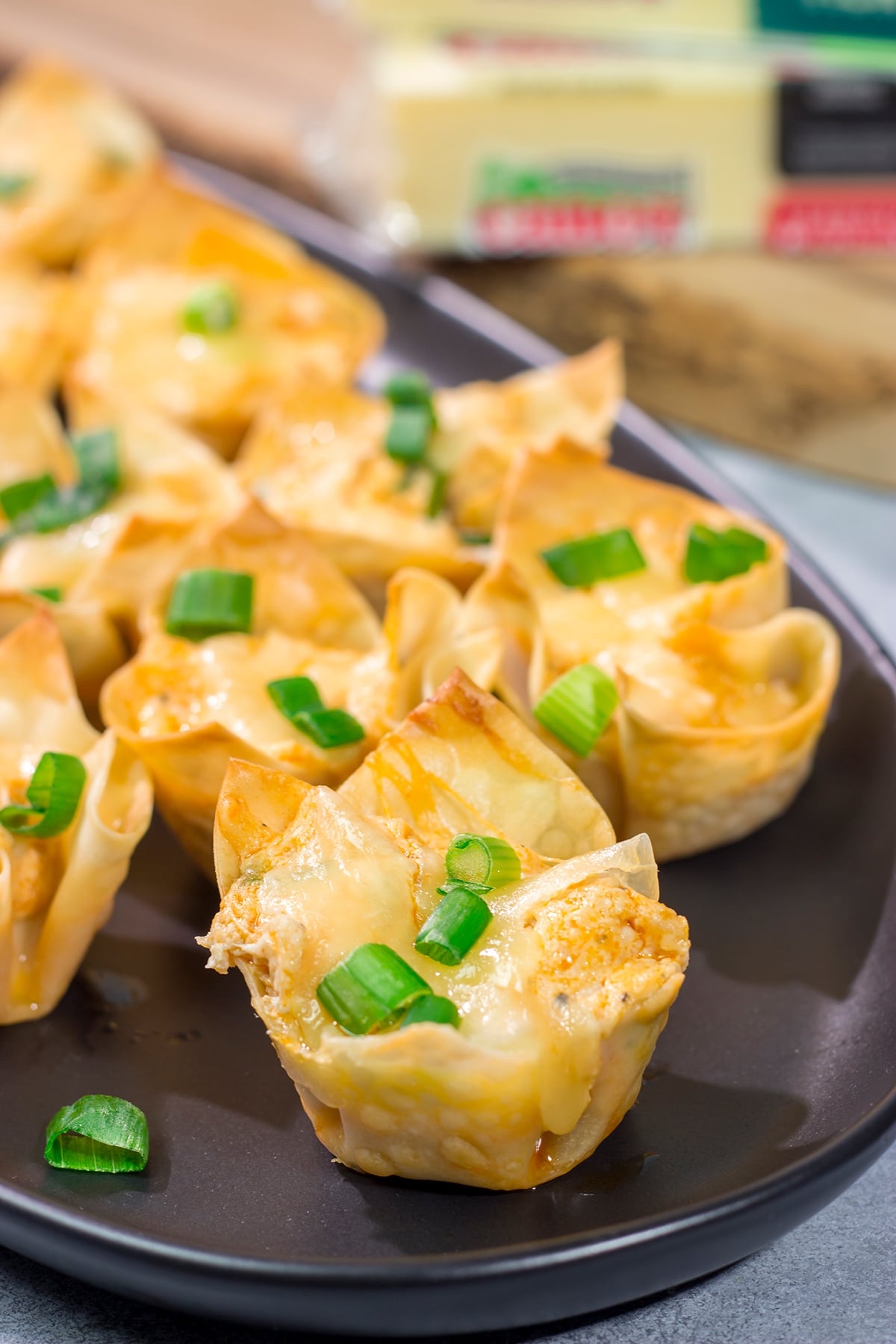 These Buffalo Chicken Wonton Cups feature creamy, mouthwatering buffalo chicken dip...in a bite-sized form!