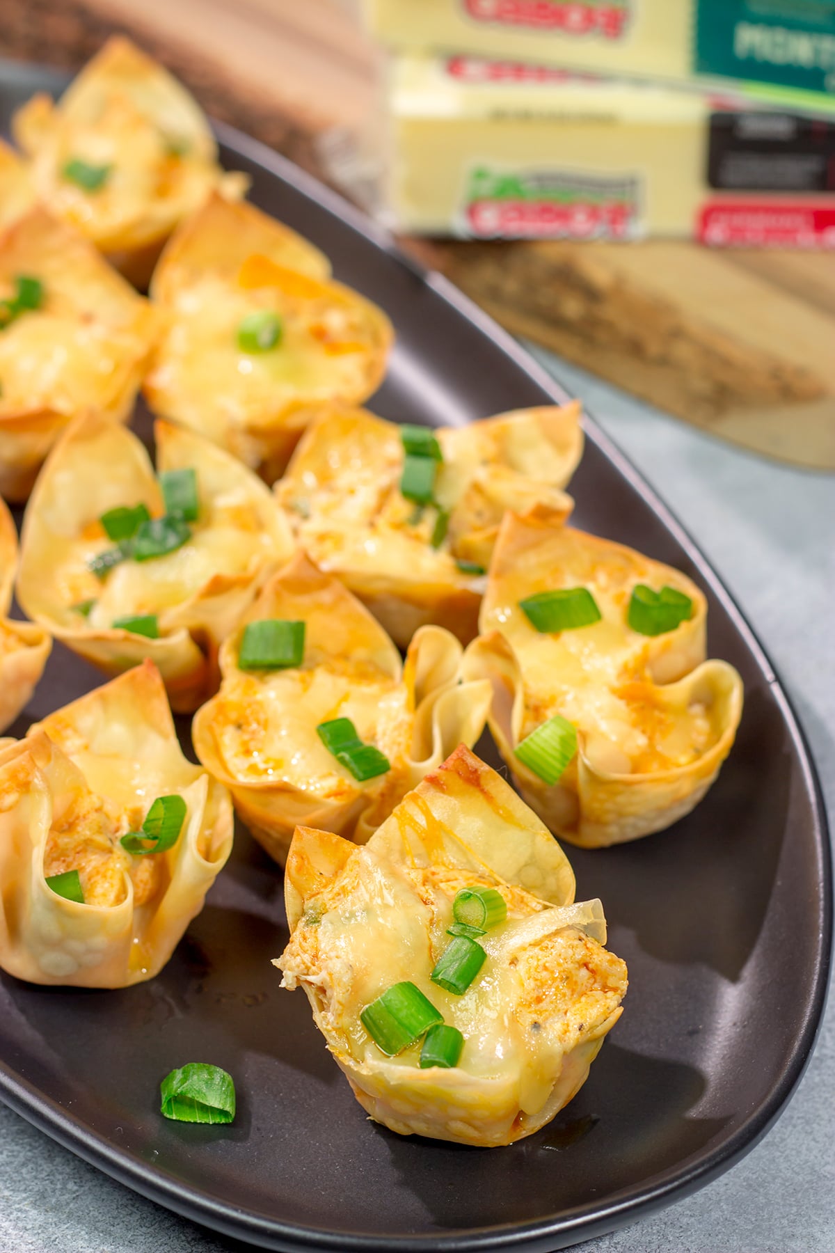 These Buffalo Chicken Wonton Cups feature creamy, mouthwatering buffalo chicken dip...in a bite-sized form!