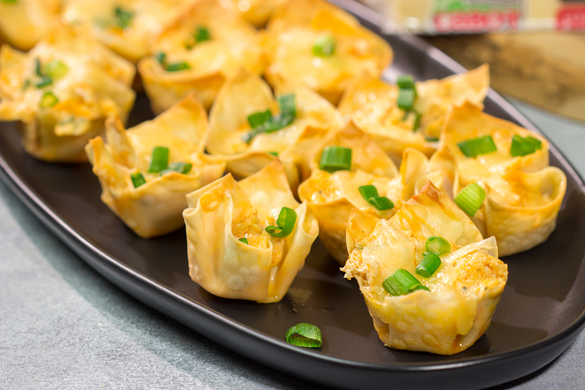 These Buffalo Chicken Wonton Cups feature creamy, mouthwatering buffalo chicken dip...in a bite-sized form!
