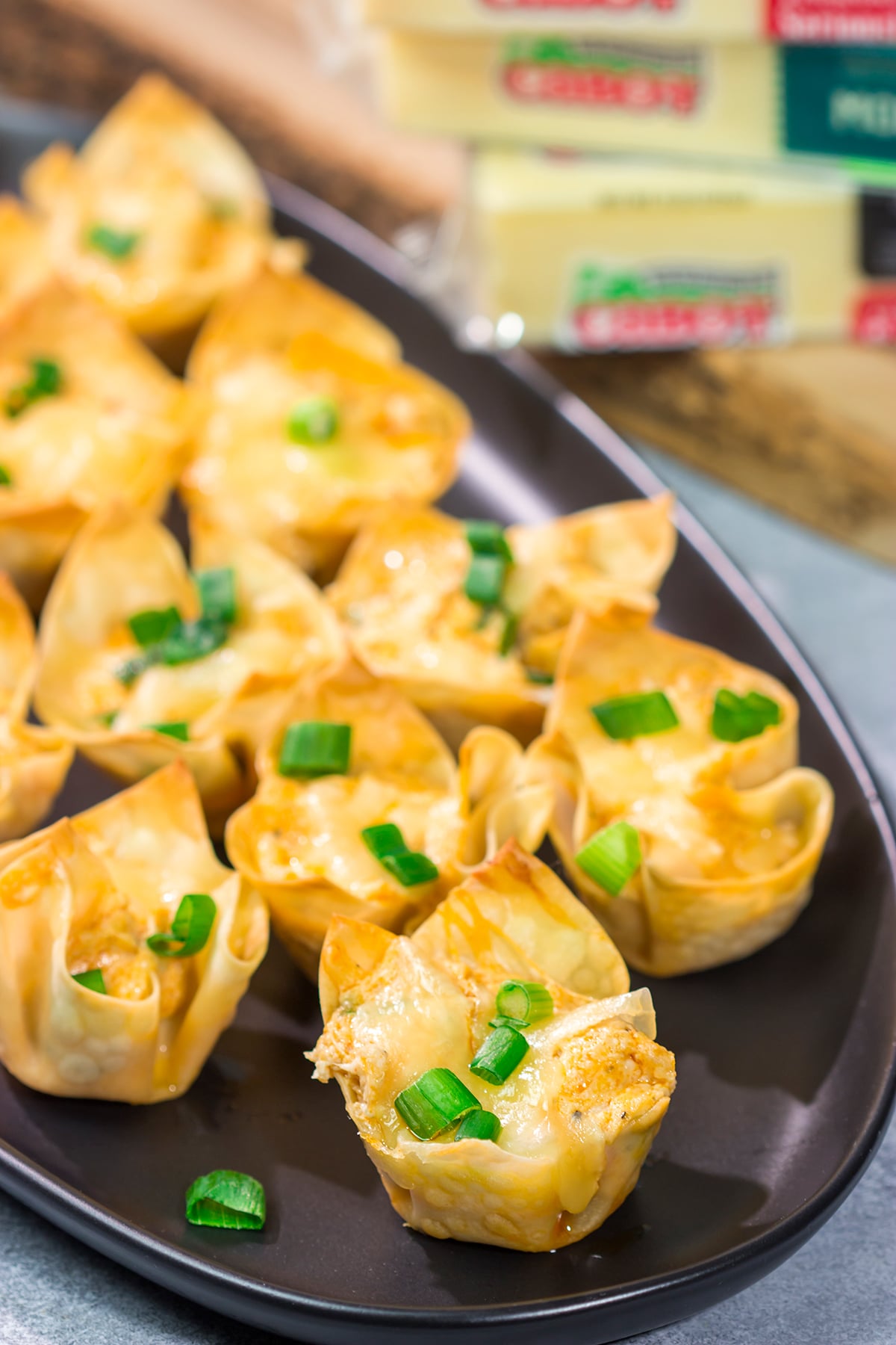 These Buffalo Chicken Wonton Cups feature creamy, mouthwatering buffalo chicken dip...in a bite-sized form!