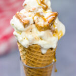 This Caramel Praline Ice Cream features a creamy vanilla base filled with nutty crumbled pralines. It's delicious, and it's perfect for a hot summer day!