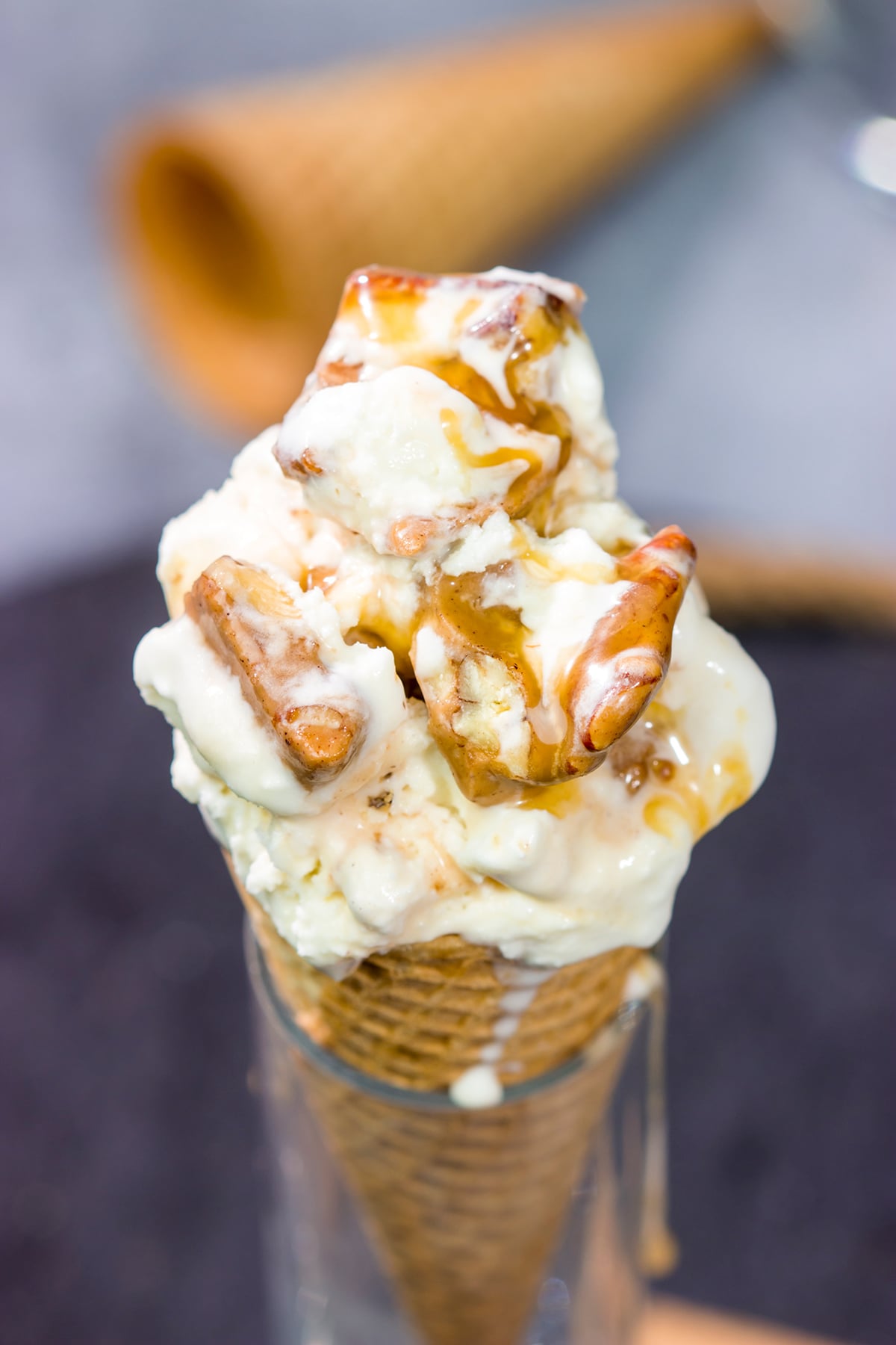 This Caramel Praline Ice Cream features a creamy vanilla base filled with nutty crumbled pralines. It's delicious, and it's perfect for a hot summer day!