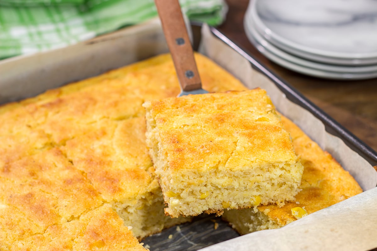 This Cornbread with Creamed Corn recipe is a mouthwatering recipe that can be whipped up in about 10 minutes. It's a delicious year-round side dish!