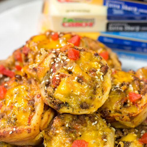Skip the buns and grab some pizza dough instead! These Cheeseburger Pinwheels feature seasoned beef with cheddar cheese...and they're baked in a muffin tin!