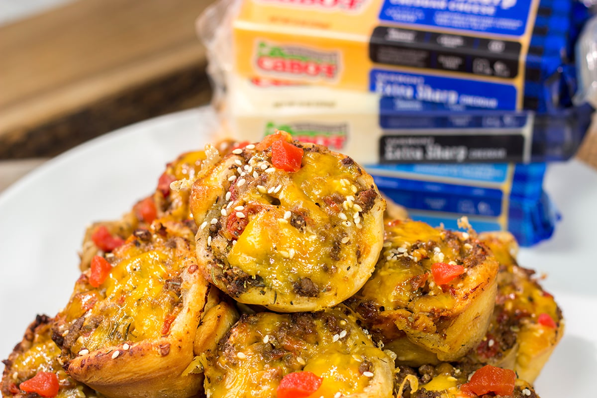 Skip the buns and grab some pizza dough instead! These Cheeseburger Pinwheels feature seasoned beef with cheddar cheese...and they're baked in a muffin tin!