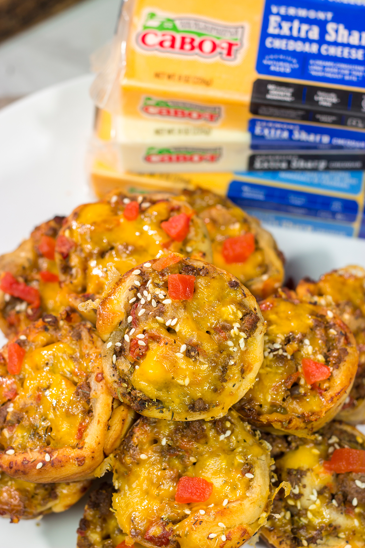 Skip the buns and grab some pizza dough instead! These Cheeseburger Pinwheels feature seasoned beef with cheddar cheese...and they're baked in a muffin tin!