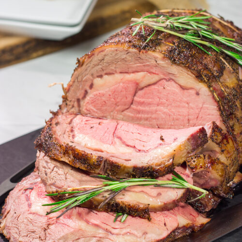 Smoked Prime Rib is a company worthy meal! This prime rib roast (aka standing rib roast) is slow-smoked for flavor and then seared to create a delicious exterior crust.