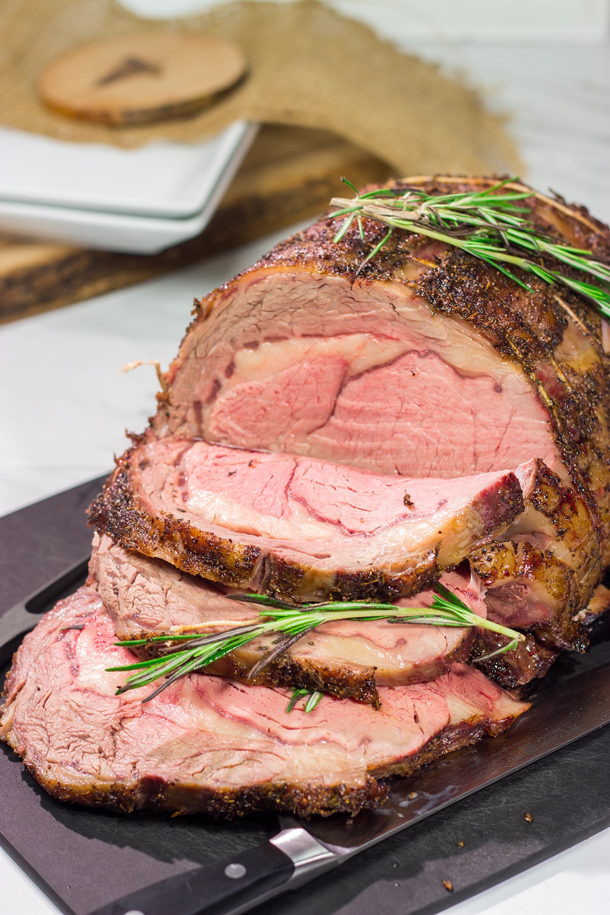 Smoked Prime Rib is a company worthy meal! This prime rib roast (aka standing rib roast) is slow-smoked for flavor and then seared to create a delicious exterior crust.