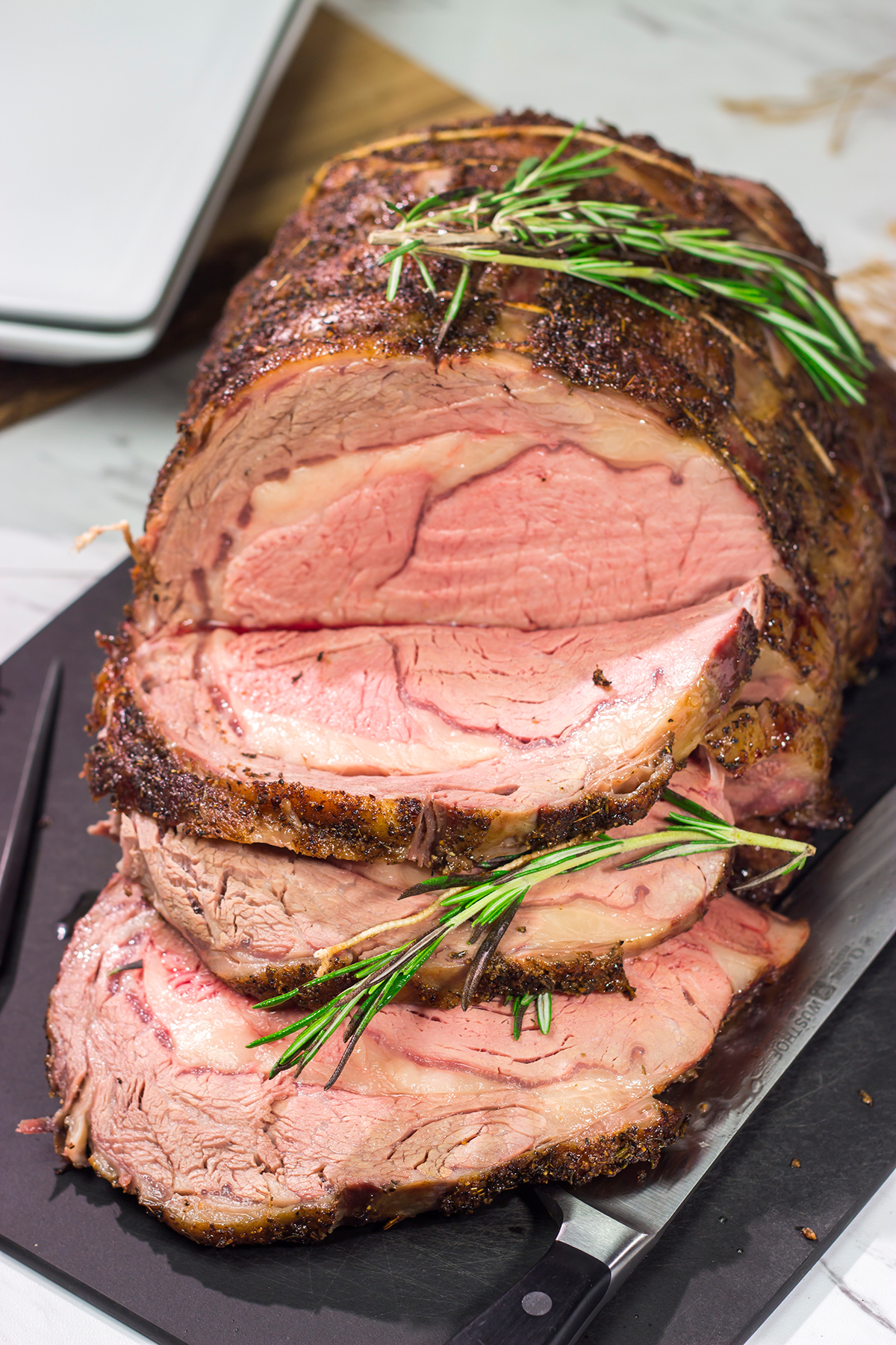 Smoked Prime Rib is a company worthy meal! This prime rib roast (aka standing rib roast) is slow-smoked for flavor and then seared to create a delicious exterior crust.