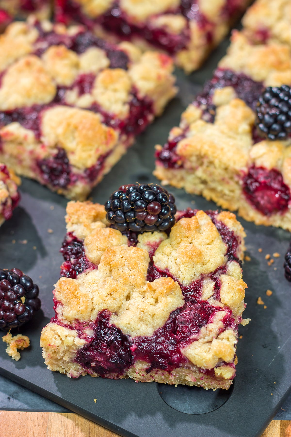 These Blackberry Crumb Bars are similar to a summer berry crumble...just in handheld form! They're filled with blackberry flavor, and they're easy to make!