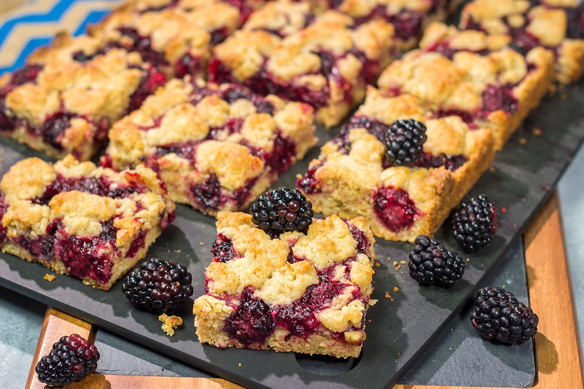 These Blackberry Crumb Bars are similar to a summer berry crumble...just in handheld form! They're filled with blackberry flavor, and they're easy to make!