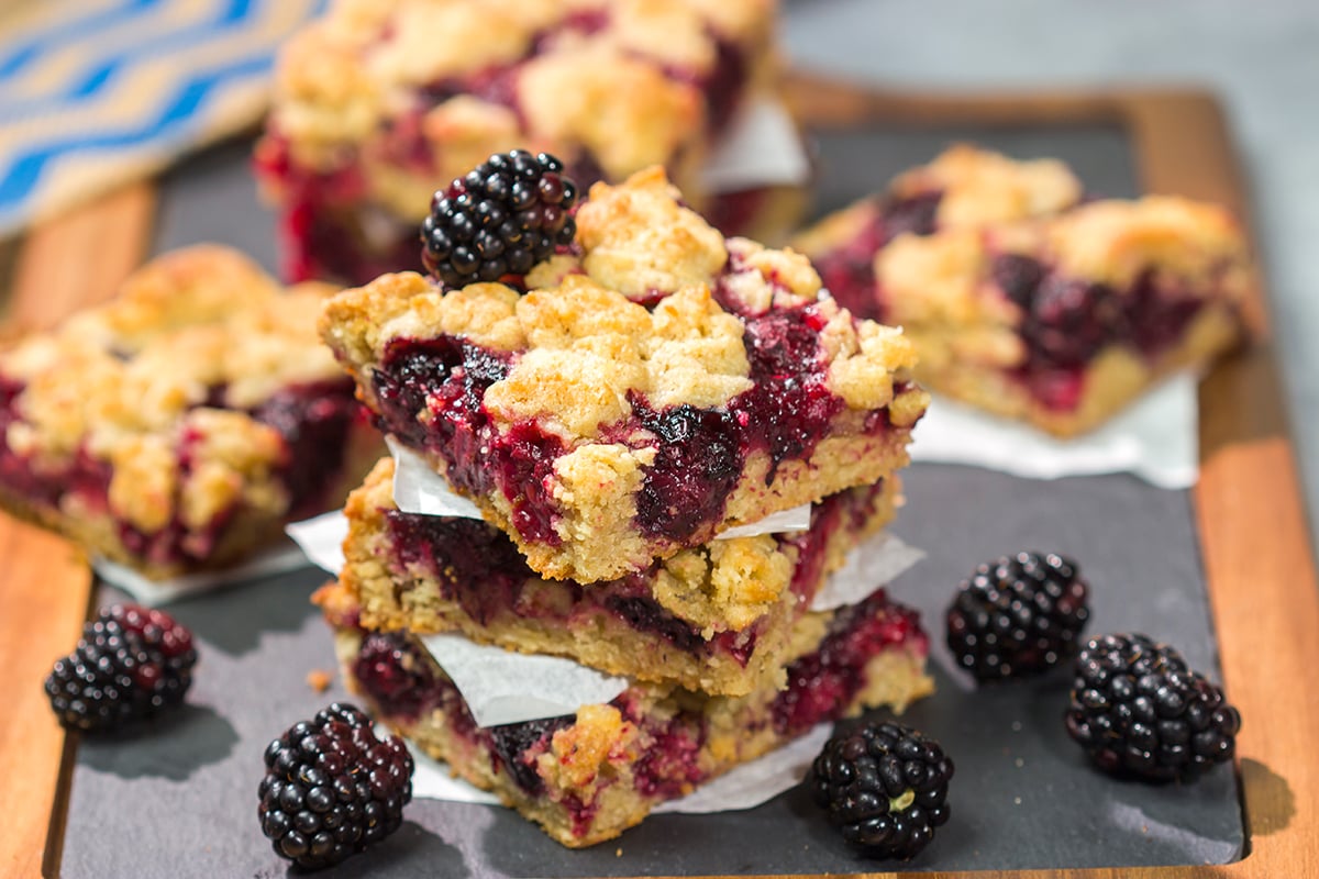 These Blackberry Crumb Bars are similar to a summer berry crumble...just in handheld form! They're filled with blackberry flavor, and they're easy to make!