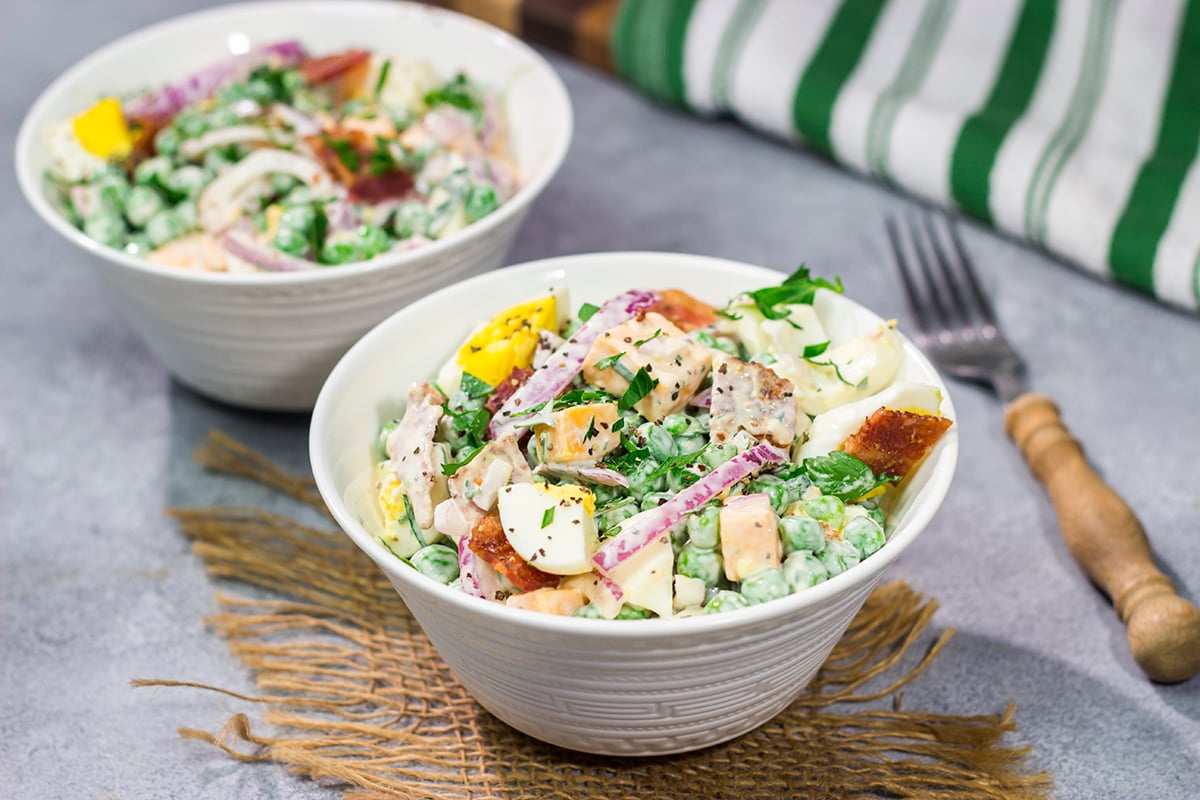 Packed with bacon and cheese, this Easy Pea Salad is a colorful and delicious side dish for summer meals and potlucks!
