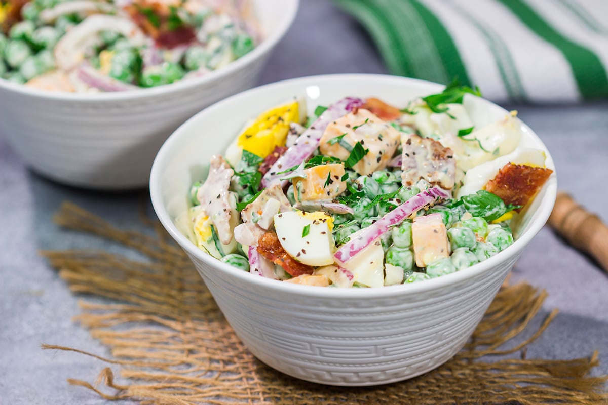 Packed with bacon and cheese, this Easy Pea Salad is a colorful and delicious side dish for summer meals and potlucks!