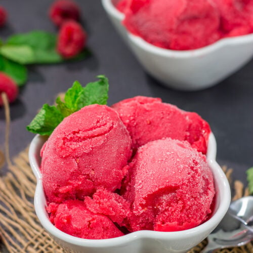 Looking for a tasty summer dessert? Whip up a batch of this Raspberry Sorbet! This dairy-free treat is perfect for warm summer evenings!